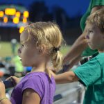 Pretty Spectator Random girl watching cheerleaders from the stands at a high school football game